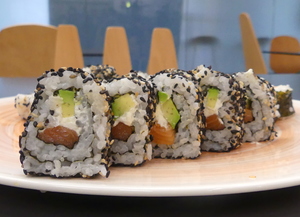Uramaki sushi with salmon, avocado and cheese