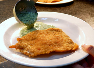 Breaded and pan fried pork loin stuffed with ham and cheese, spinach cream