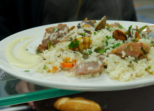 Paella with rabbit, clams , mussels and garlic cream