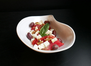 Tomato, fresh cheese, walnuts and black olives salad 
