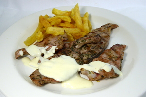 Grilled turkey chop with baked potatoes and cheese sauce