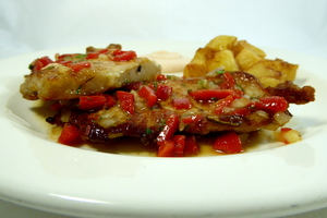 Grilled pork chop with vinaigrette, rissole potatoes and mayonnaise tomato sauce 