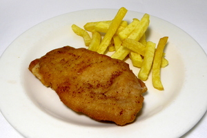 Breaded pan fried pork loin stuffed with ham and cheese served with chips