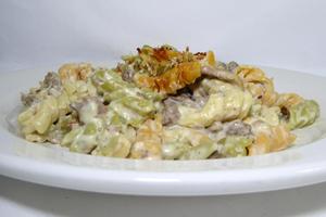 Spiral shaped Italian pasta with minced meat and Mornay sauce