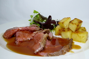 Roasted veal with rissolé potatoes and green salad 
