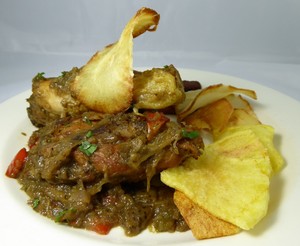 World cuisine.Nigerian style chicken stew with yuca chips and fried plantain