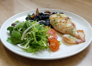 Grilled squid with black risotto and salad