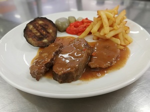 Veal cheeks stew seasoned with Pedro Ximenez and garnished with potatoes, aubergine, red pepper and glassed chalota