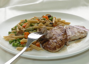 Pork tenderloin with whole grain pasta and vegetables jardiniére