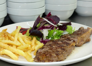 Grilled rib eye with salad, piquillo peppers and French fries